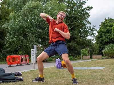 One dancer does a solo piece. He stands with his legs apart, knees bent and elbows pointing out. He grooves to the music.