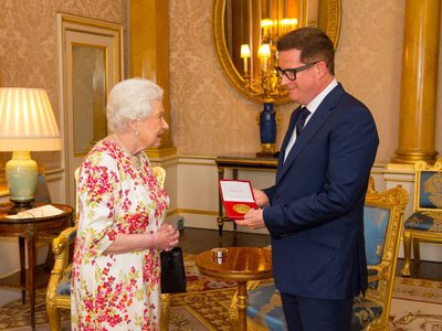 Matthew receiving the Queen Elizabeth II Coronation (QEII) Award from Her Majesty The Queen
