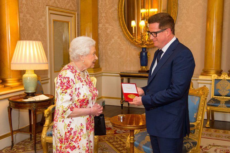 Matthew receiving the Queen Elizabeth II Coronation (QEII) Award from Her Majesty The Queen