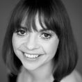 headshot of woman with short bobbed hair and fringe