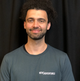 mixed Caribbean/white male with dark afro hair.