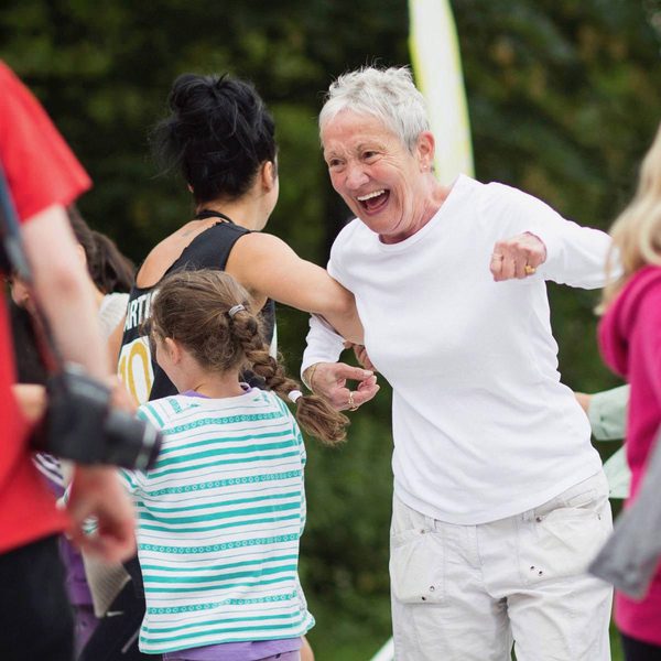 Middle-aged woman having fun dancing with young people